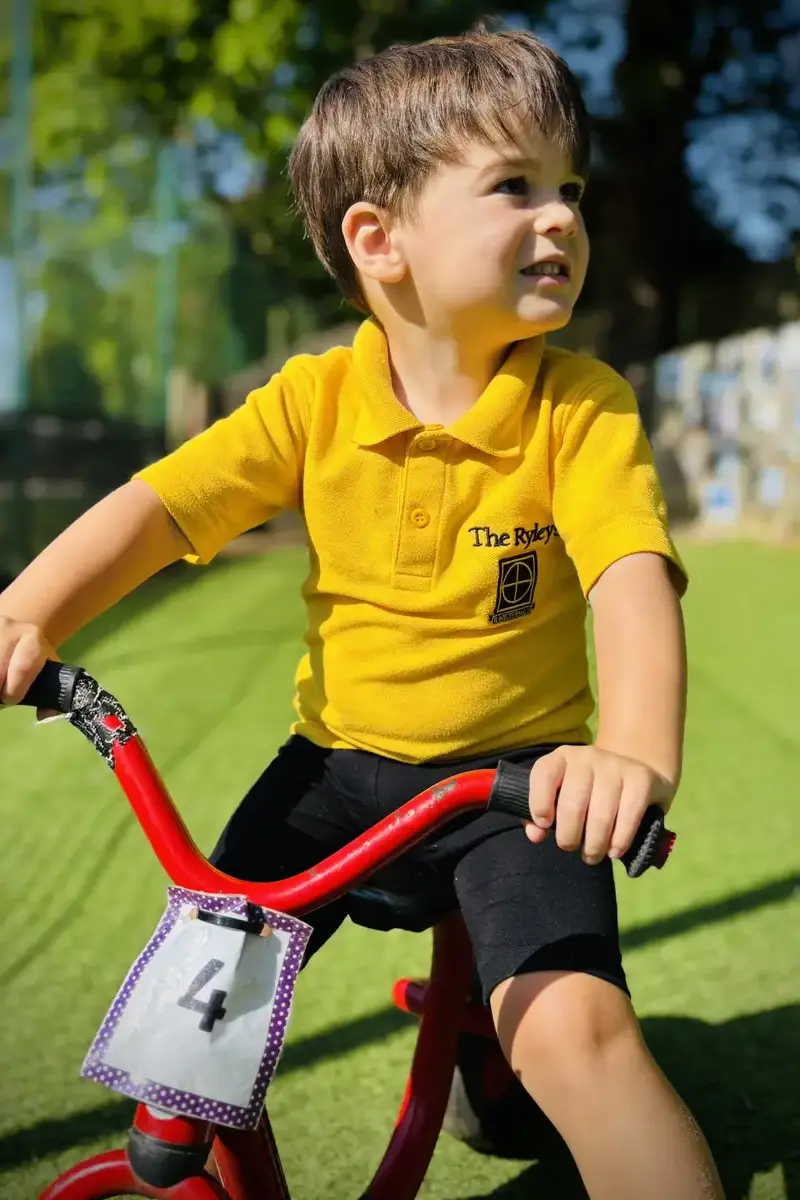 Early Years Pupil at The Ryleys School, and independant Prep School in Alderley Edge, Cheshire on a red bikeNews Post Image Portrait